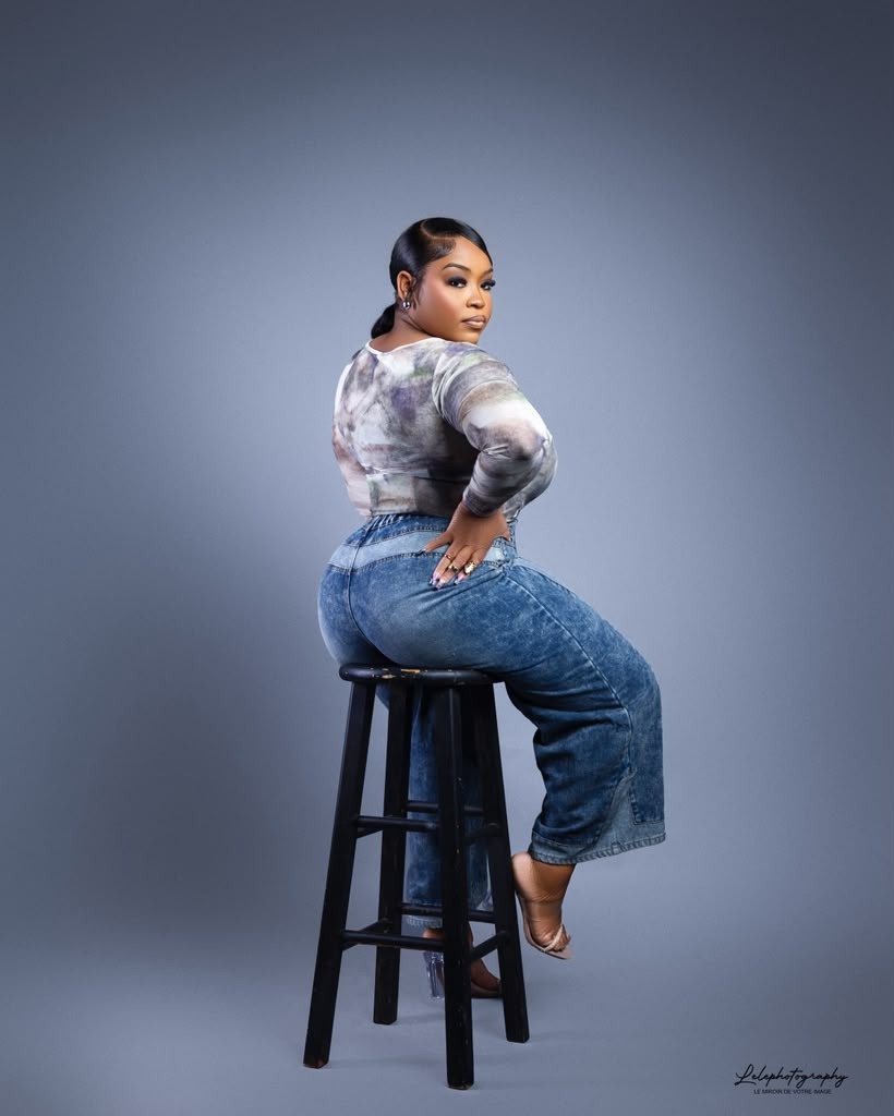 Studio portrait on stool with neutral backdrop and classic posing